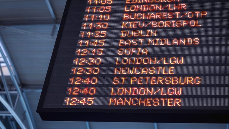Airport departures board listing European flights, where entry requirements are checked before boarding