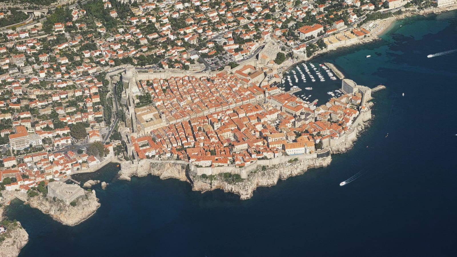 The walled Old Town of Dubrovnik and its harbour from the air, Croatia