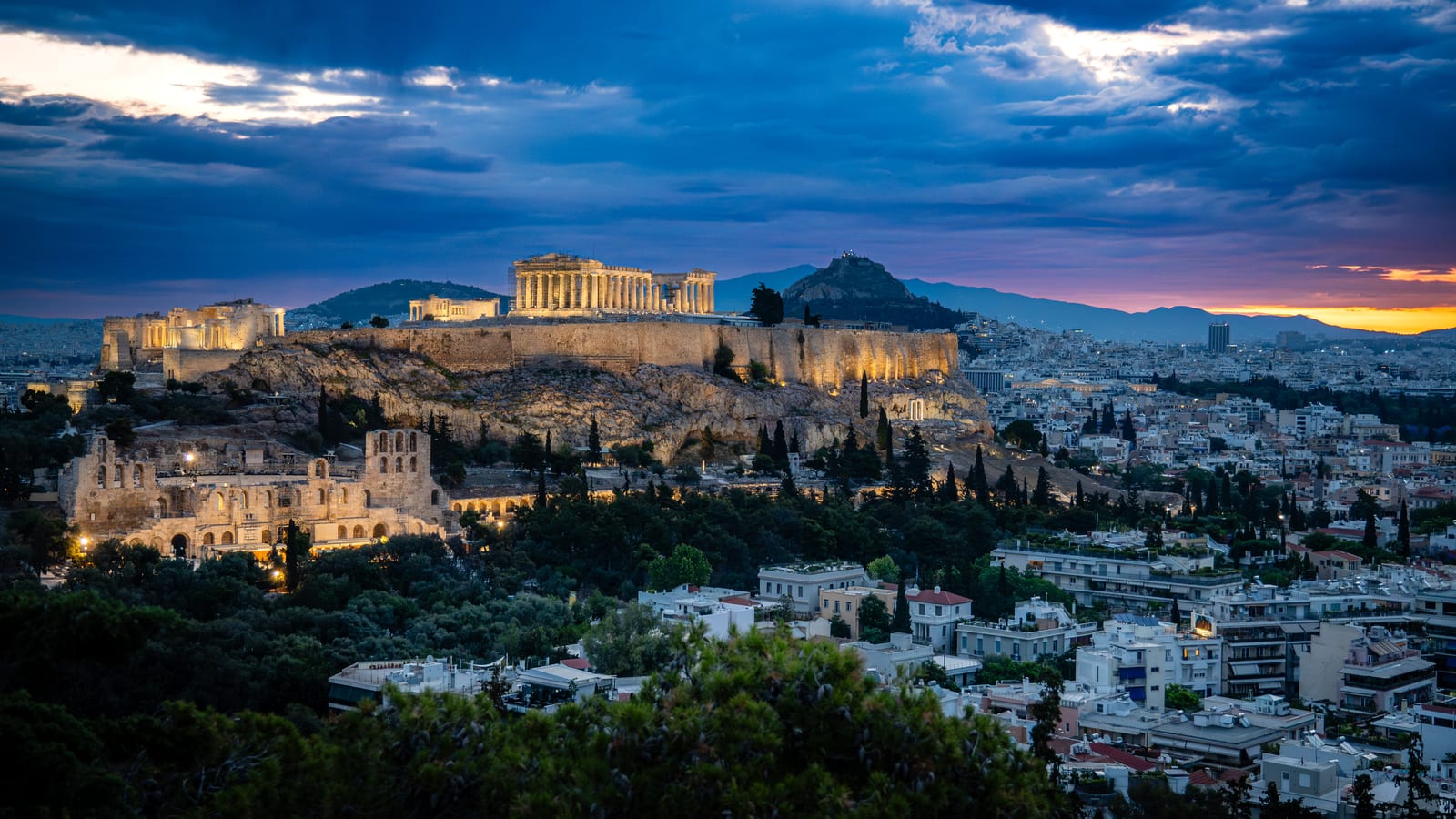 The Acropolis and Parthenon lit at daybreak above the Athens skyline, Greece