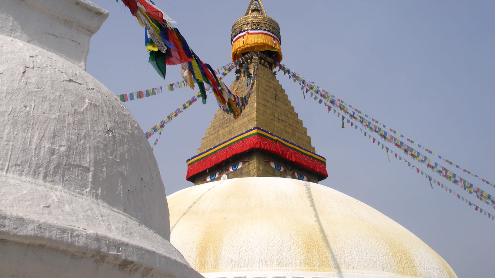 Prayer flags and the painted eyes of Boudhanath stupa, Kathmandu, Nepal
