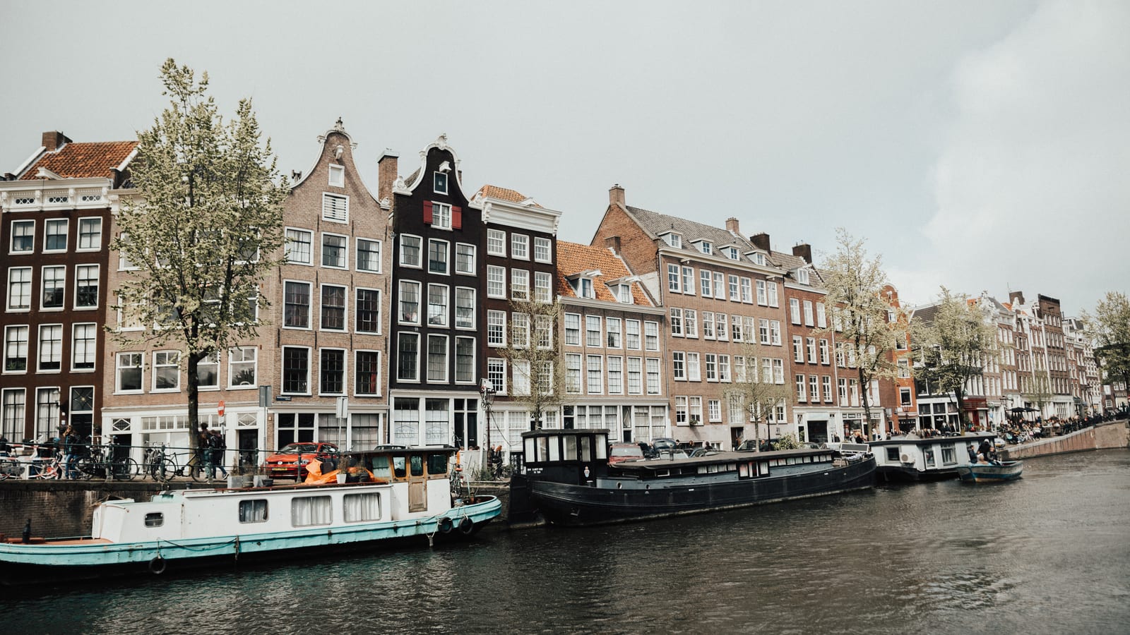 Canal houses and moored boats along an Amsterdam canal, the Netherlands